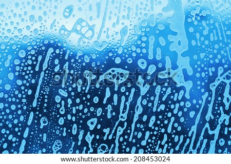 Background with soap foam bubbles on the glass