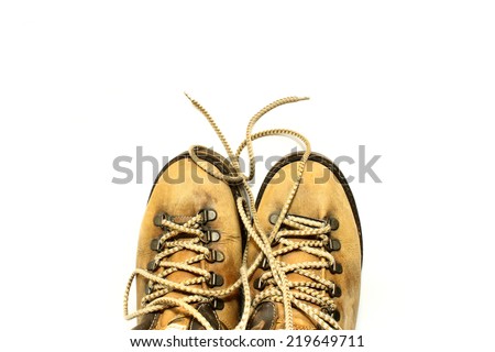 Yellow shoes with untied shoelaces on white background