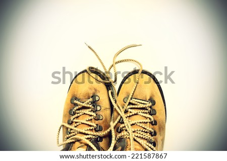 Vintage background yellow shoes with untied shoelaces