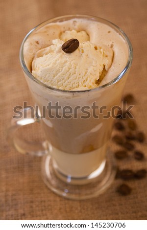 Glass of coffee with vanilla ice cream float and a coffee bean on the top