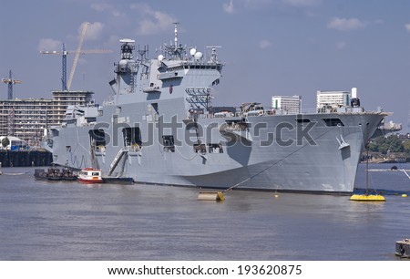 London, England, UK - August 8, 2012: Britain\'s helicopter carrier HMS Ocean, the Royal Navy\'s largest in the fleet, anchored on the River Thames along side Greenwich during the Olympic Games in 2012.