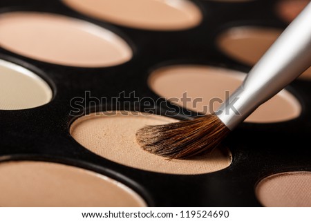 Close-up of eyeshadow palette with brush