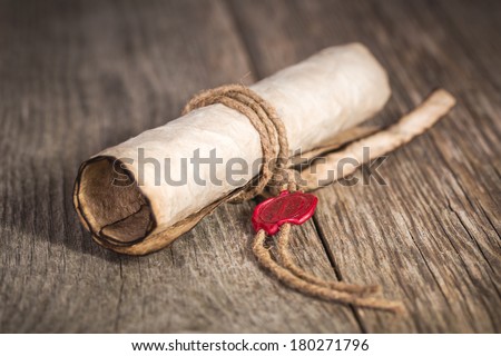 Old scroll paper on wooden background.