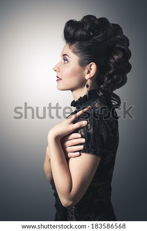 Fashion portrait of an attractive young woman. With professional make-up and hair style. With handmade jewelry.