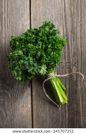 Organic fresh parsley on wooden background.