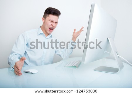 A furious businessman frustrated with his lack of wireless connection and or computer skills