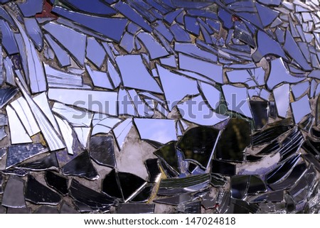 Broken  mirror and reflection on sky background