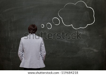 man with thought bubble on chalk board, rear view