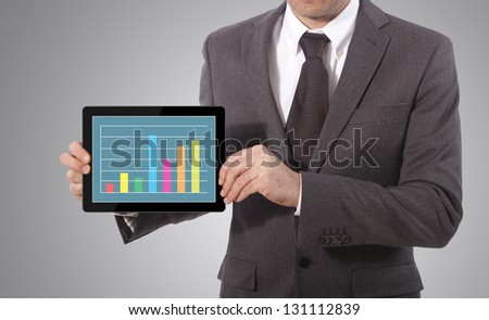 business man hand touch screen graph on a tablet