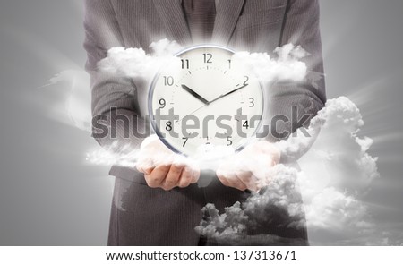Business man holding clock, world map from www.lib.utexas.edu