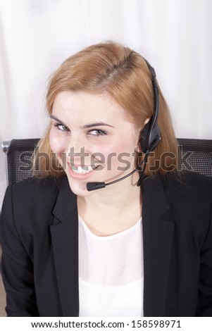 Closeup of customer service executive smiling and looking
