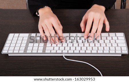 Businesswoman typing at computer in office