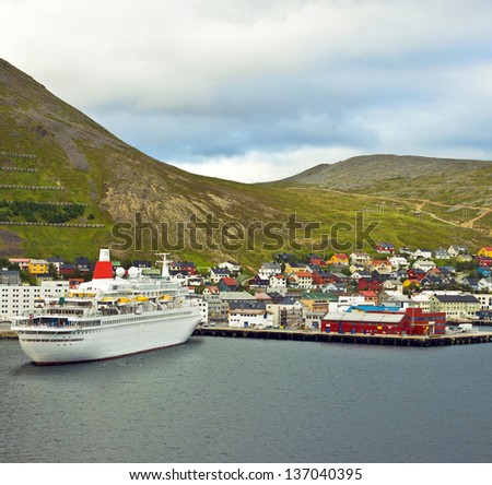 HONNINGSVAG, NORWAY: Cruise ship in harbor of Honningsvag in Norwegian fjords. Honningsvag is small Norwegian town and sea port beyond the Arctic Circle.