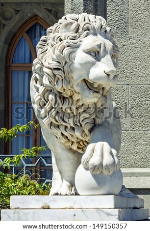 Lion sculpture - marble sculpture of lion with ball in Vorontsov Palace in the town of Alupka, Crimea, Russia.