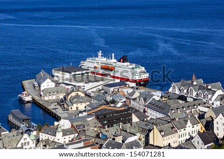 ALESUND, Norway - Norwegian cruise liner Hurtigruten came into Alesund harbor in Norwegian fjords. Alesund is noted for its unique Art Nouveau architecture.