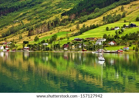 Rural houses and yacht in cruise port Olden in Cruise port Olden in Norwegian fjords, Norway.