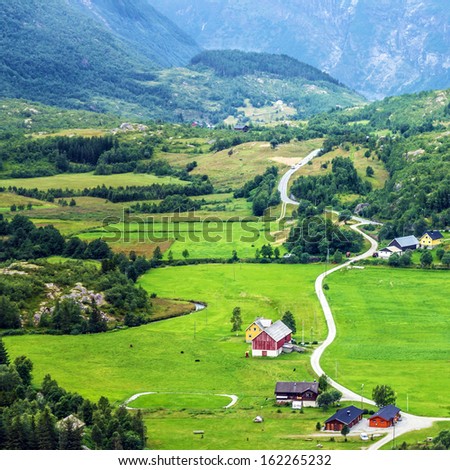 Village houses in mountains. Geiranger, Norway - mountain Dalsnibba landscape with country houses.