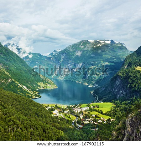 Norway Landscape Mountains And Village In Geiranger Fjord.