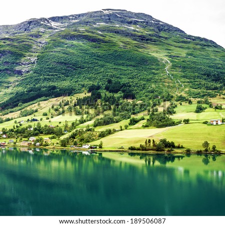 Natural landscape, Scandinavia. Olden in Norwegian fjords. Tourist camping on the beach.