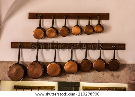 Copper kitchen utensil on the wall - Interior of royal kitchen in National Palace of Sintra, Portugal