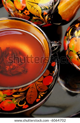 Traditional russian decorated tea service, tea cup with tea.