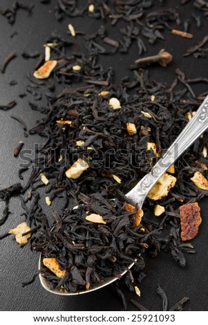 Black dry tea leaves in a spoon