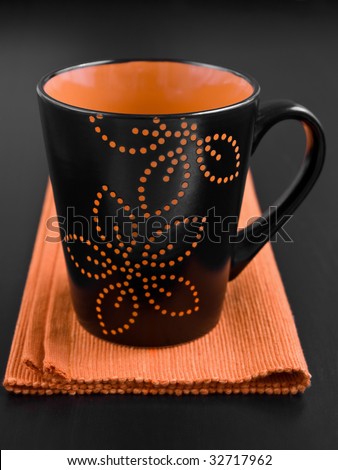 A black decorated mug on the table