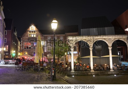 AACHEN, GERMANY, APRIL 11, 2014: People are sitting and chatting while drinking beer on terraces of various pubs and restaurants in german Aachen.