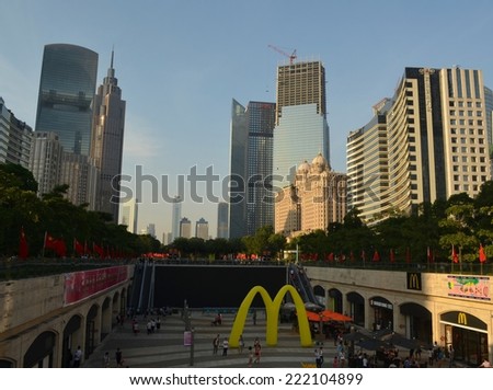 GUANGZHOU, CHINA, OCTOBER 2, 2013: People are passing by through the main shopping boulevard leading from the pearl river to tianhe in guangzhou, which is surrounded by tall skyscrapers.