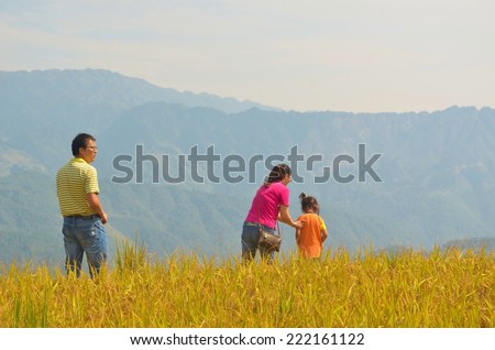 LONGJI, CHINA, OCTOBER 5, 2013: Chinese family is admiring dragon backbone - longji rice terraces in china during golden week holiday.