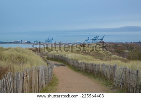 Coastal road leading to the port full of heavy machinery in belgium.