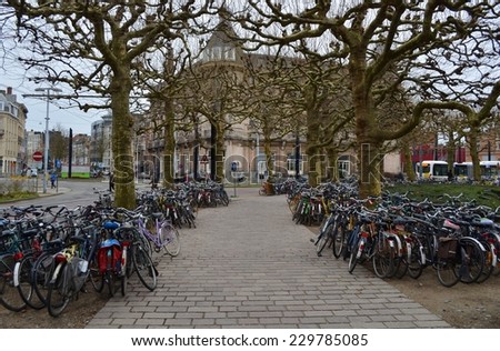 GENT, BELGIUM, JANUARY 25, 2014: Bicycles are locked to each other in front of the train station in Gent.