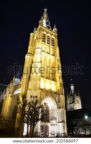 View of the illuminated tower of the church inside belgian city ypres.