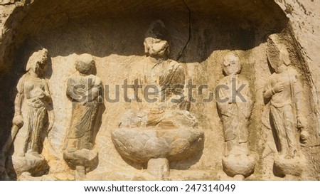 LUOYANG, CHINA, AUGUST 27, 2013: detail of buddha statues and various decoration in longmen grottoes complex, where thousands of buddha statues are carved into the rock.