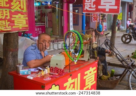 PINGYAO, CHINA, AUGUST 22, 2013: Man is selling locks and chains on the street of pingyao in china,