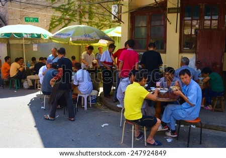 SHANGHAI, CHINA, SEPTEMBER 1, 2013: people are having lunch on a street in suburb area of shanghai.