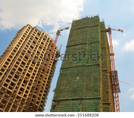 two skyscrapers under construction in chinese city luoyang.