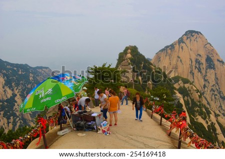 HUASHAN, CHINA, AUGUST 26, 2013: steep stairway leading to the top of huashan mountain in china is full of tourist willing to see this mountain range from above.