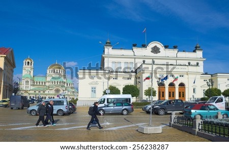 SOFIA, BULGARIA, NOVEMBER 15, 2014: People are passing by in front of national assembly and alexandr nevski cathedral in sofia.