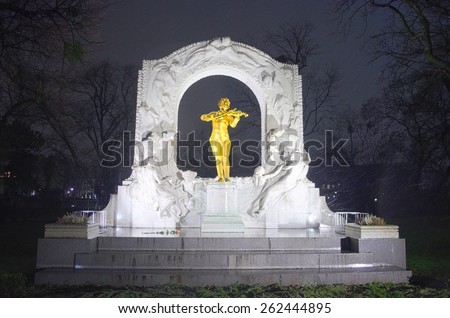 WIEN, AUSTRIA, JANUARY 4, 2015: night view of the illuminated statue of music composer johann strauss situated in a park in wien. picture taken during heavy snow storm.
