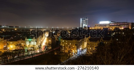 night view of the prague congress center, nuselsky bridge and valley filled with houses below them in prague.
