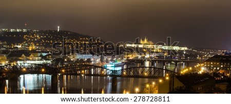 night view of the prague castle and railway bridge over vltava/moldau river in prague taken from the top of vysehrad castle.