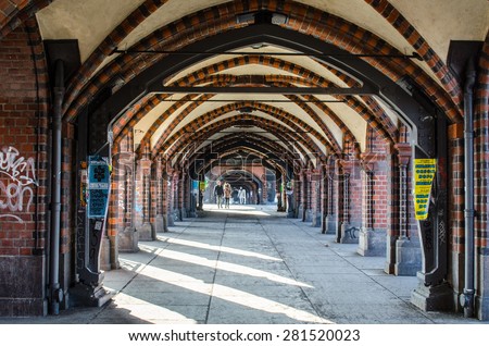 BERLIN, GERMANY, MARCH 12, 2015: brick arcs of oberbaumbrucke creates covered passage for pedestrians in berlin.