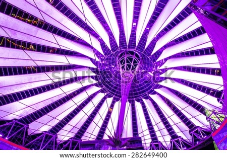 giant copula of sony center in berlin is made of white strips and is illuminated during night