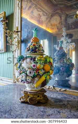 CASERTA, ITALY - JUNE 1: refelction of a vase with fruit motives in a mirror inside of the italian palace Caserta near naples.