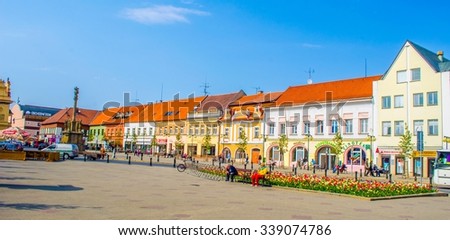 PODEBRADY, CZECH REPUBLIC, APRIL 28, 2015: people are strolling through the main square of czech city podebrady which is dominated by statue of the czech king jiri z podebrad.