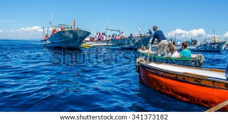 CAPRI, ITALY, MAY 15, 2014: peoplea re waiting on various boats in order to get into the famous grotta azzura situated on capri island in the bay of naples.