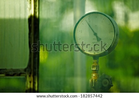 Old style manometer gauge shot thru green glass