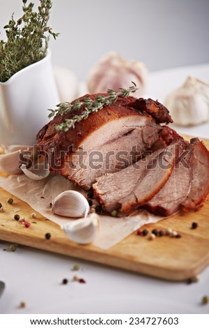 Roasted meat sliced on paper and wooden deck