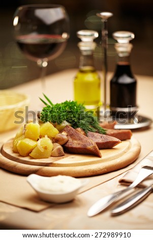 Beef tongue with potatoes and glass of wine dinner